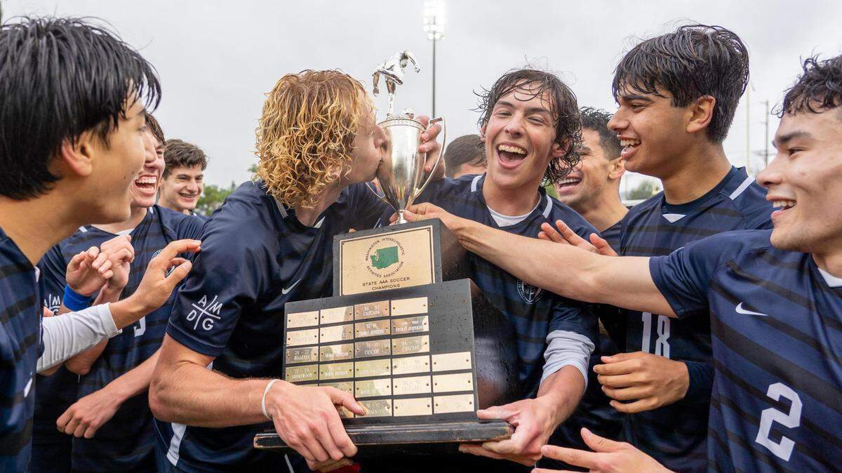 The Bellarmine boys soccer team holds the championship trophy celebrating their 1-0 4A State Championship win at Sparks Stadium in Puyallup, WA., on Saturday May 28, 2022.