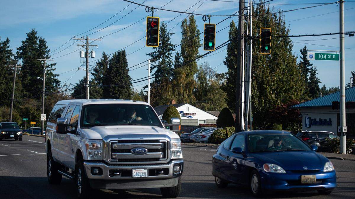 Cars drive along Canyon Road through the intersection at 104th Street East in Summit, Wash., on Friday, Oct. 11, 2019.