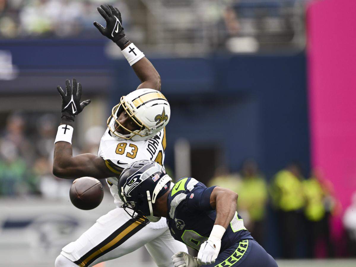Seattle Seahawks safety Coby Bryant (8) hits New Orleans Saints tight end Juwan Johnson (83) as a errant pass flies past during the first quarter of the game at Lumen Field, on Sunday, Sept. 21, 2025 in Seattle.