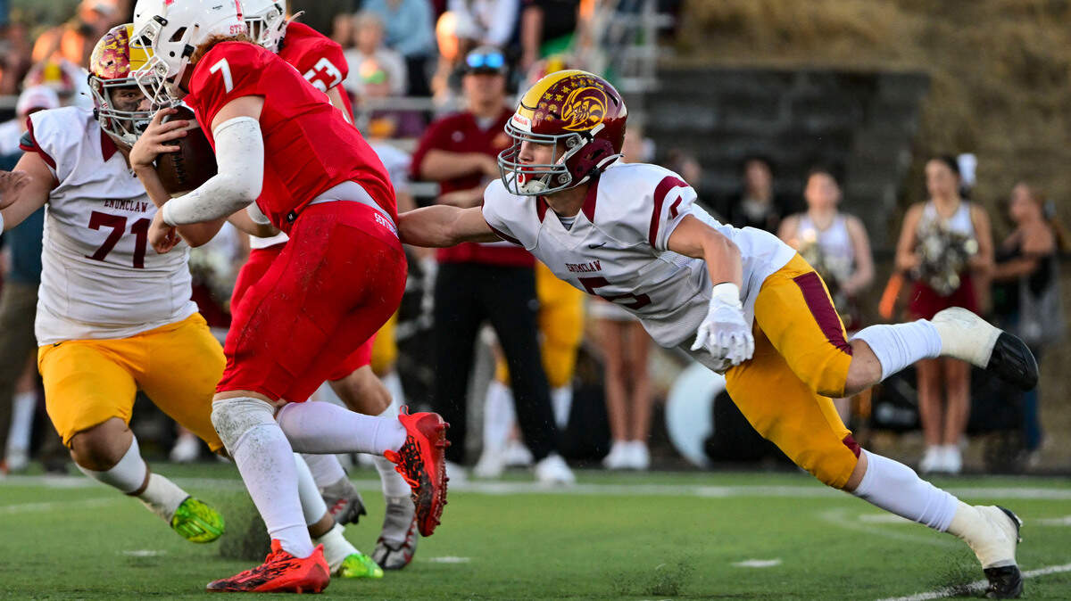 Enumclaw’s Colton Paulson (5) tackles Steilacoom quarterback Drew Macdonald (7) in the backfield during the first quarter of a 2A SPSL game on Friday, Sept. 15, 2023, in Steilacoom, Wash.