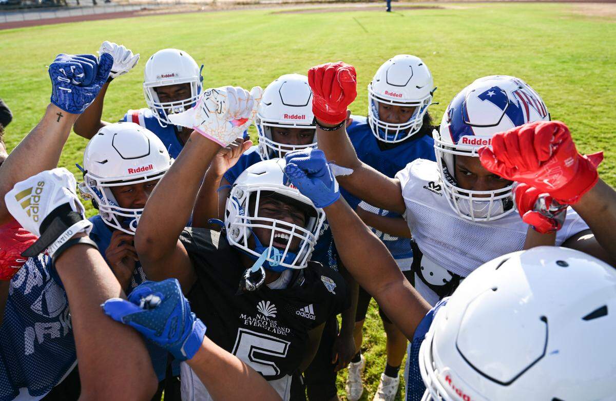 Washington student-athletes huddle during a practice at Washington High School, Monday, Aug. 21, 2023, in Tacoma, Wash.