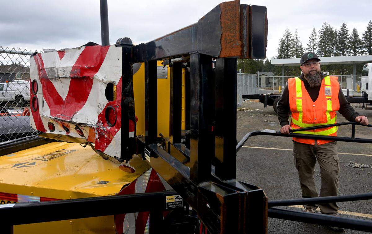 Standing near a truck-mounted attenuator crushed in a wreck, WSDOT highway maintenance worker Adam Gonzales talks about the three times he’s been hit in work zones – two in Pierce County and one in Thurston County. March 19, 2024.