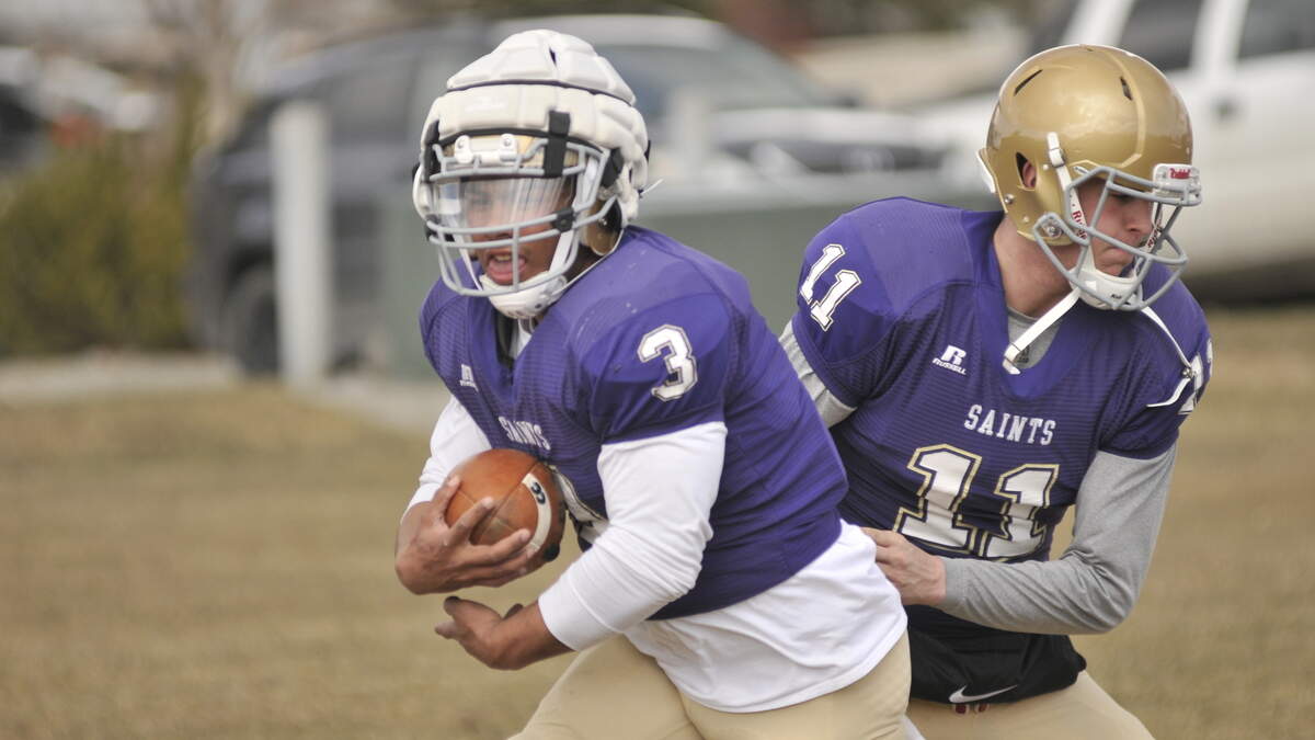 Carroll College running back and Peninsula High grad Major Ali takes a handoff in spring practice from Idaho State transfer Robert Kvinsland, also a Peninsula grad. The two former Peninsula teammates have reuinted this season in Montana.