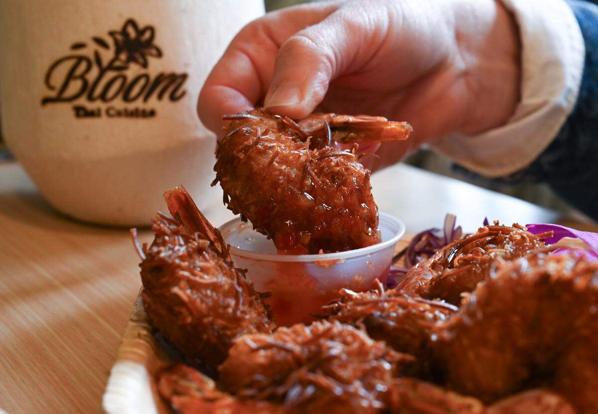 The homemade coconut prawns are awash in sweet, shredded flakes and fried to a beautiful amber.