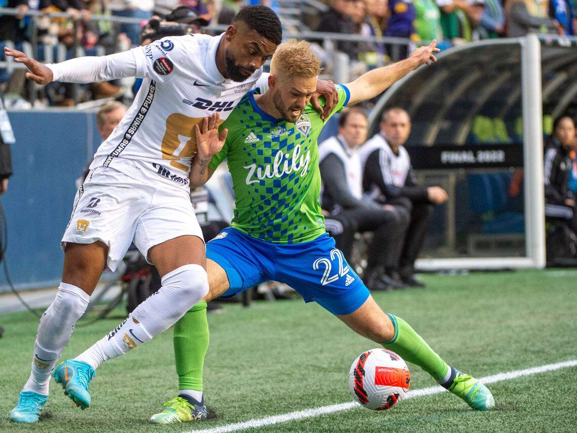 Pumas forward Diogo De Oliveira (33) and Seattle Sounders midfielder Kelyn Rowe (22) fight for a ball along the sideline during the first half of the second leg of the CONCACAF Champions League Final at Lumen Field in Seattle, on Wednesday, May 4, 2022.