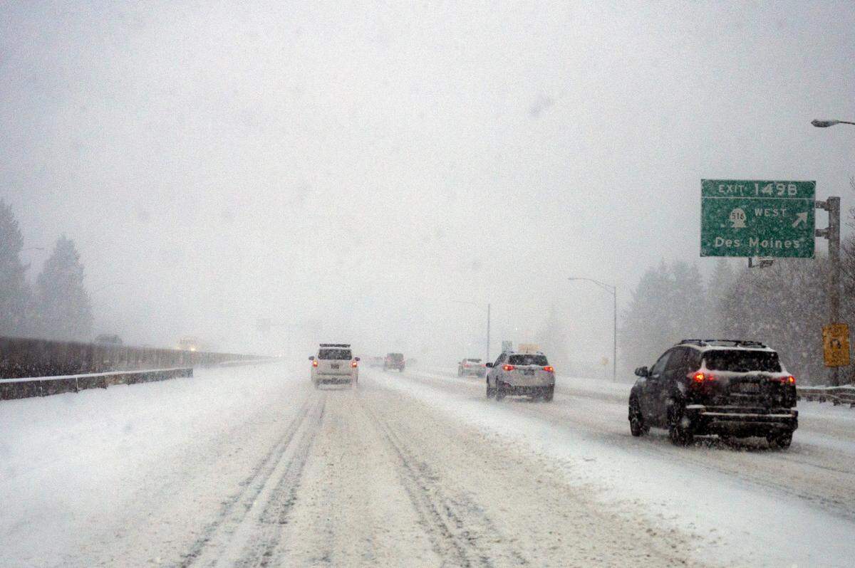 Northbound traffic on Interstate 5 maneuvers over the snow-packed roadway Sunday morning north of Tacoma near the exit for Des Moines.