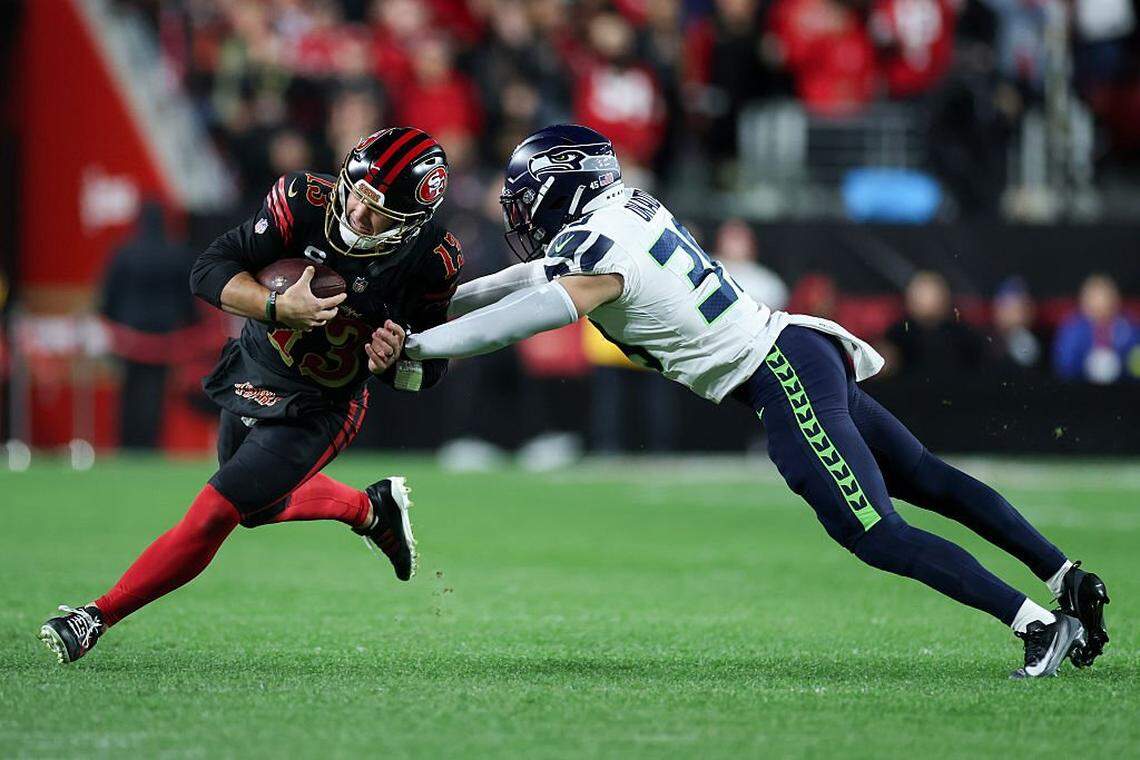 SANTA CLARA, CALIFORNIA - JANUARY 03: Brock Purdy #13 of the San Francisco 49ers carries the ball against Ty Okada #39 of the Seattle Seahawks during the second quarter of a game at Levi's Stadium on January 03, 2026 in Santa Clara, California. (Photo by Ezra Shaw/Getty Images)