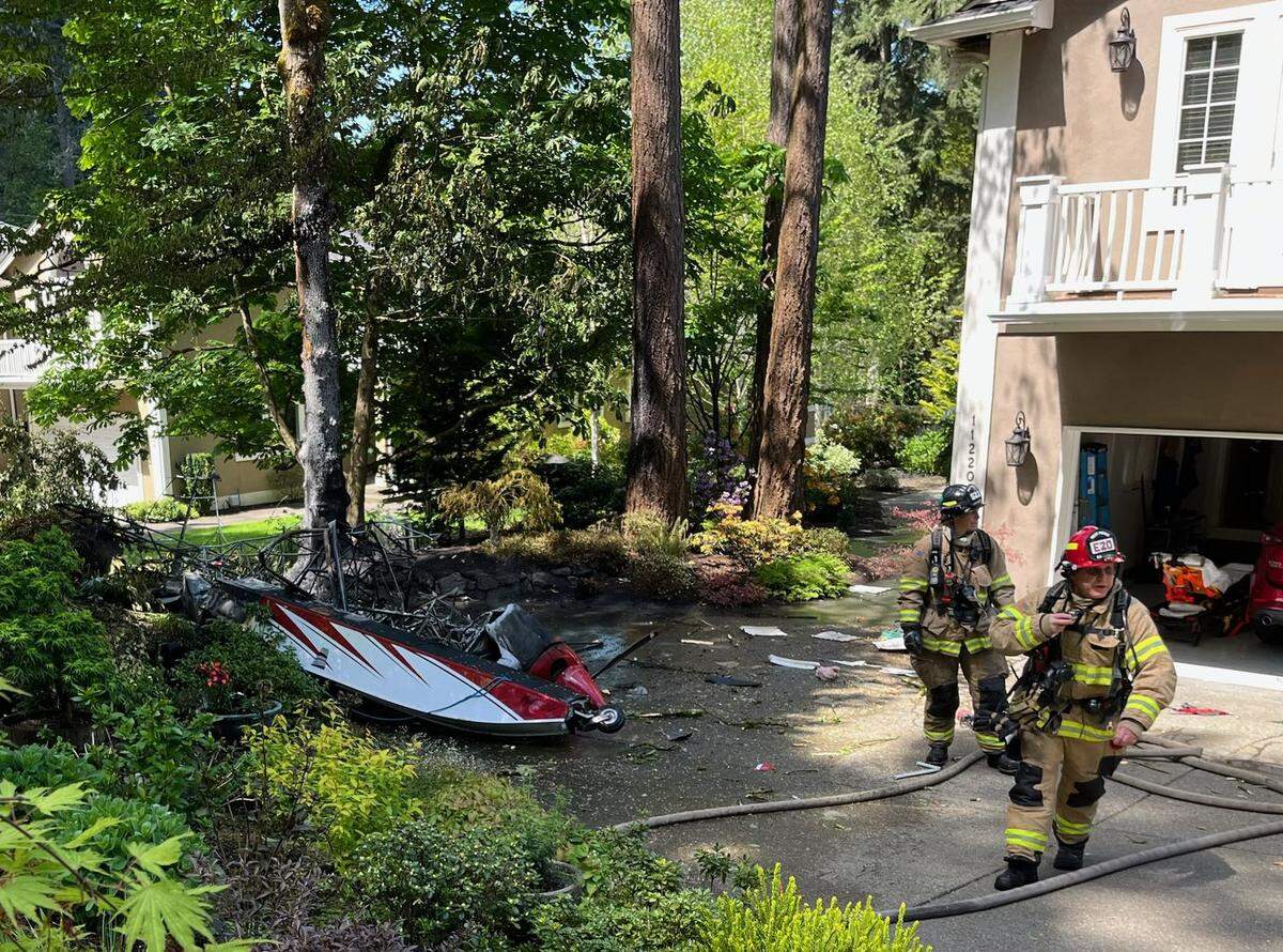 The aftermath of the floatplane crash in the driveway of Ron and Liz Cooper’s Lakewood home.