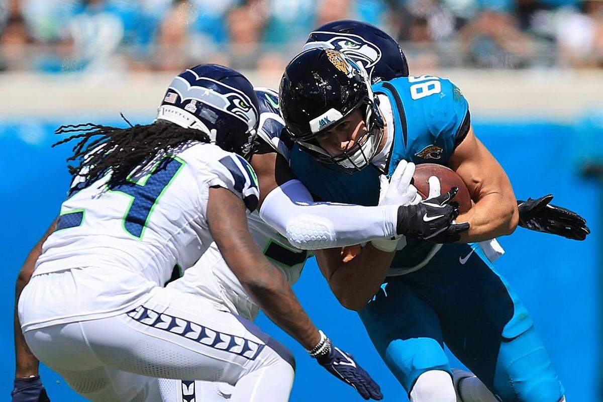 JACKSONVILLE, FLORIDA - OCTOBER 12: Brenton Strange #85 of the Jacksonville Jaguars is tackled by Boye Mafe #53 of the Seattle Seahawks during the first quarter in the game at EverBank Stadium on October 12, 2025 in Jacksonville, Florida. (Photo by Mike Carlson/Getty Images)