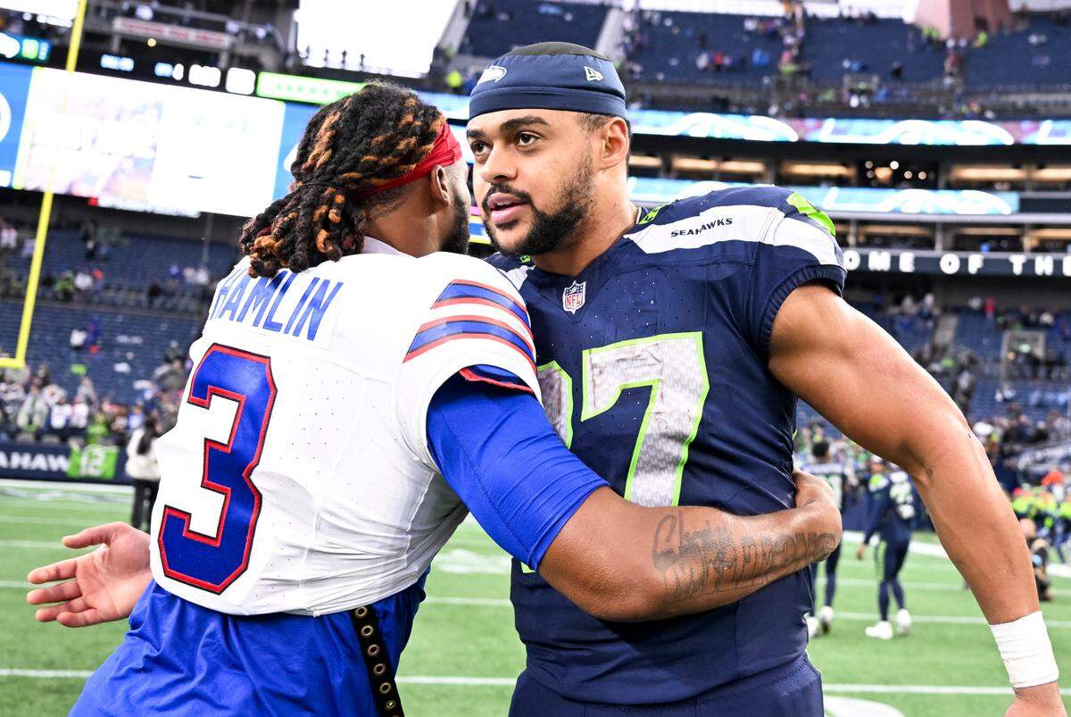 Buffalo Bills safety Damar Hamlin (3) and Seattle Seahawks tight end Noah Fant (87) embrace after the Buffalo Bills 31-10 victory against the Seattle Seahawks at Lumen Field, on Sunday, Oct. 27, 2024 in Seattle, Wash.