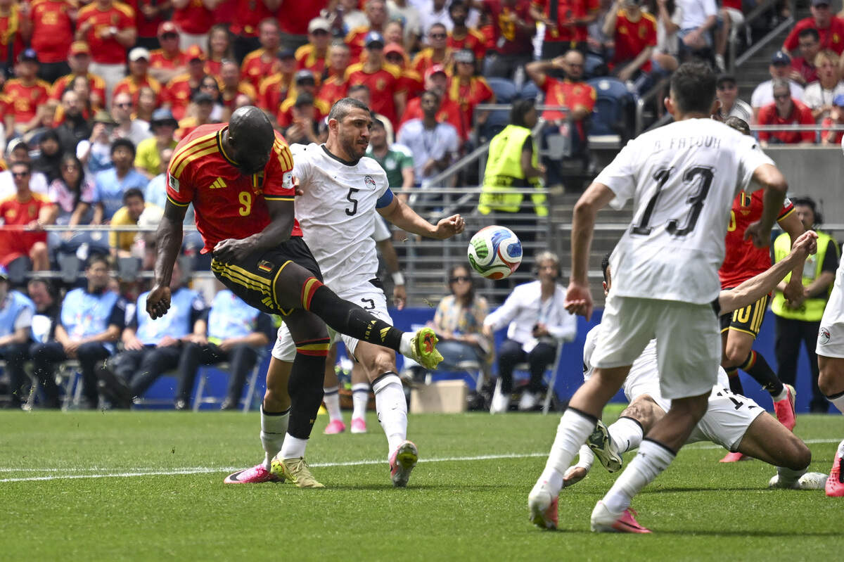 Belgium forward Romelu Lukaku (9) collides with Egypt defender Ramy Rabia (5) as Lukaku kicks the ball on Monday, June 15, 2026, during a FIFA World Cup game in Seattle, Wash.