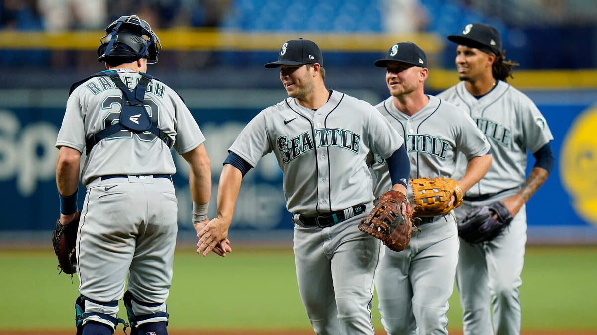 Seattle Mariners’ Ty France, second from left, celebrates with teammates, including Cal Raleigh (29) after the Mariners defeated the Tampa Bay Rays during a baseball game Monday, Aug. 2, 2021, in St. Petersburg, Fla. (AP Photo/Chris O’Meara)