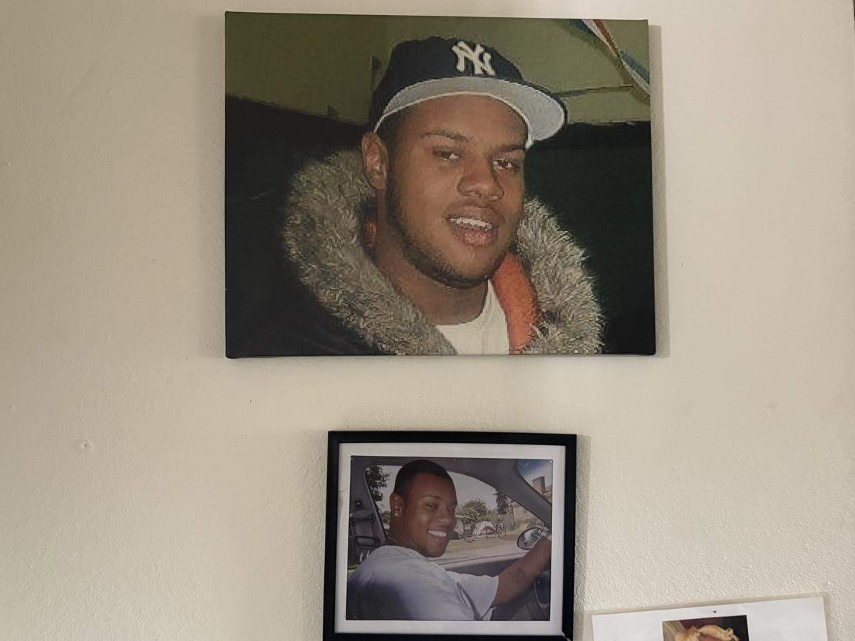 Pictures of Tiffani Robinson’s late son, Dowell Davis Thorn III, sit on her apartment wall. Eighteen years after she thought she had received all of his remains, she was notified that there were leftover cremations at a local funeral home.