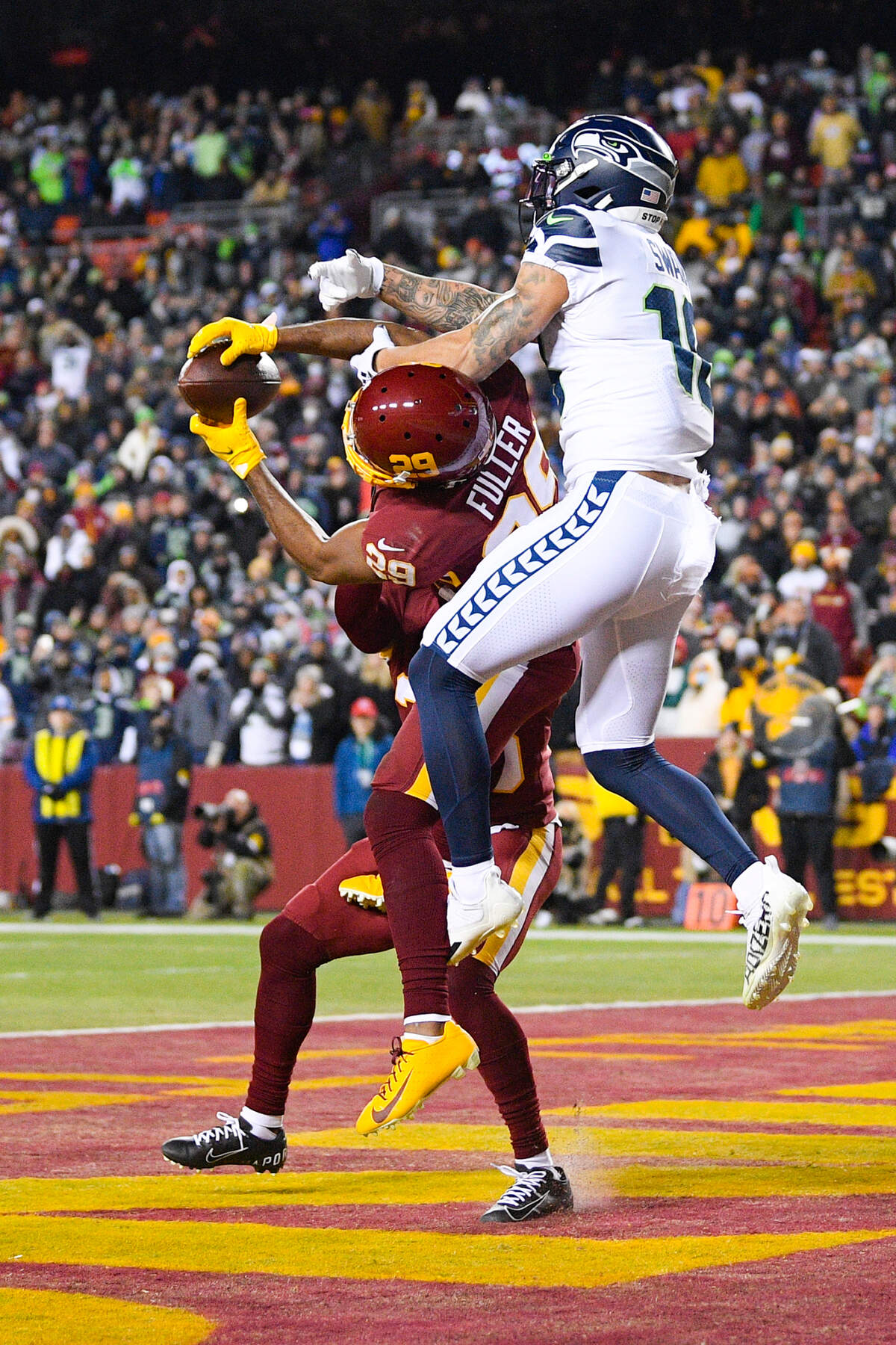 Washington Football Team cornerback Kendall Fuller (29) intercepts a pass in the end zone intended for Seattle Seahawks wide receiver Freddie Swain (18) during the second half of an NFL football game, Monday, Nov. 29, 2021, in Landover, Md. Washington won 17-15. (AP Photo/Nick Wass)