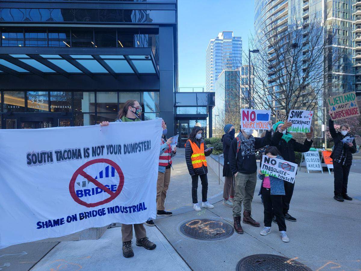 Climate Alliance of the South Sound held a protest in Bellevue in mid-March outside the building of the last publicly known Puget Sound office of Bridge Industrial protesting the development of a 4-building warehouse site in South Tacoma.