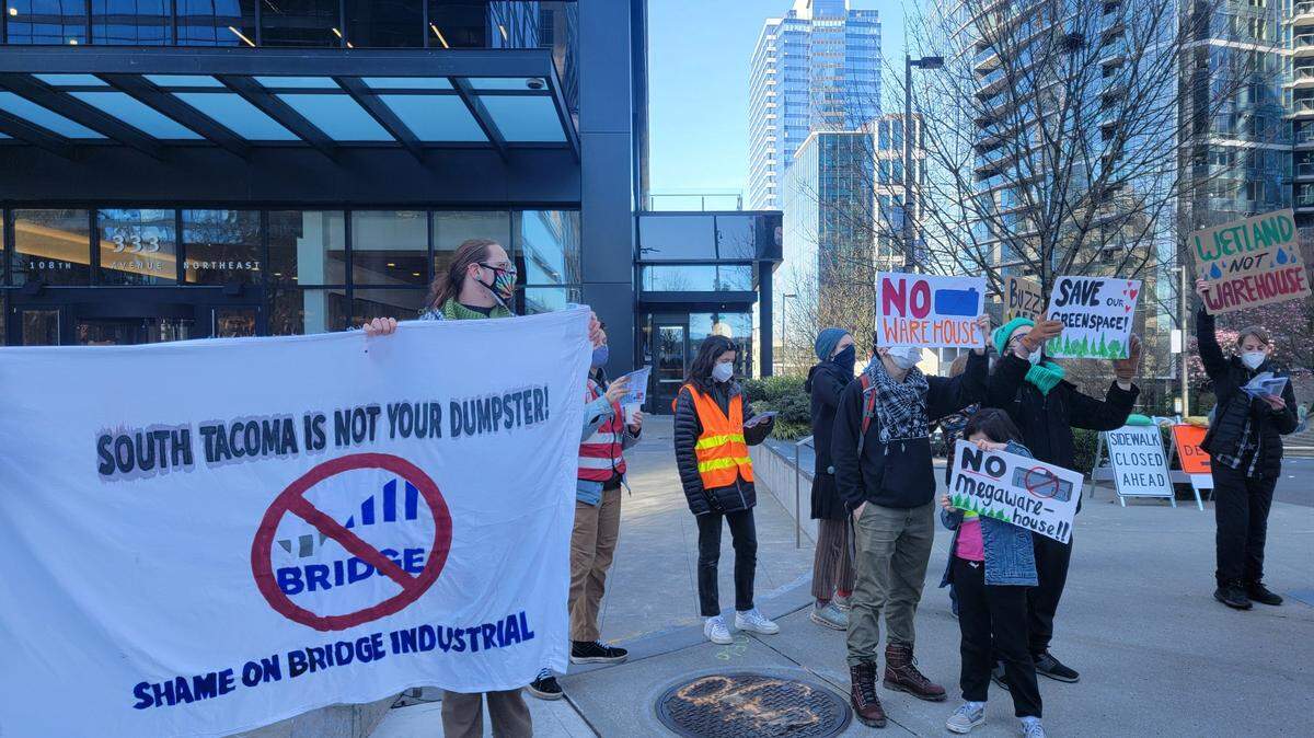 Climate Alliance of the South Sound held a protest in Bellevue in mid-March outside the building of the last publicly known Puget Sound office of Bridge Industrial protesting the development of a 4-building warehouse site in South Tacoma.