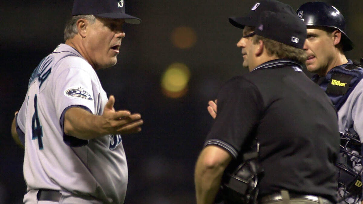 Seattle Mariners manager Lou Piniella (14) argues a first base call with home plate umpire Bill Miller, right, and first base umpire Fieldin Culbreth, center, as catcher Dan Wilson looks on during the eigth inning in Arlington, Texas, Wednesday, Sept. 11, 2002. Piniella argued that Rangers Todd Hollandsworth should have been out because of Carl Everett’s interference. The Rangers won 4-3. (AP Photo/LM Otero)