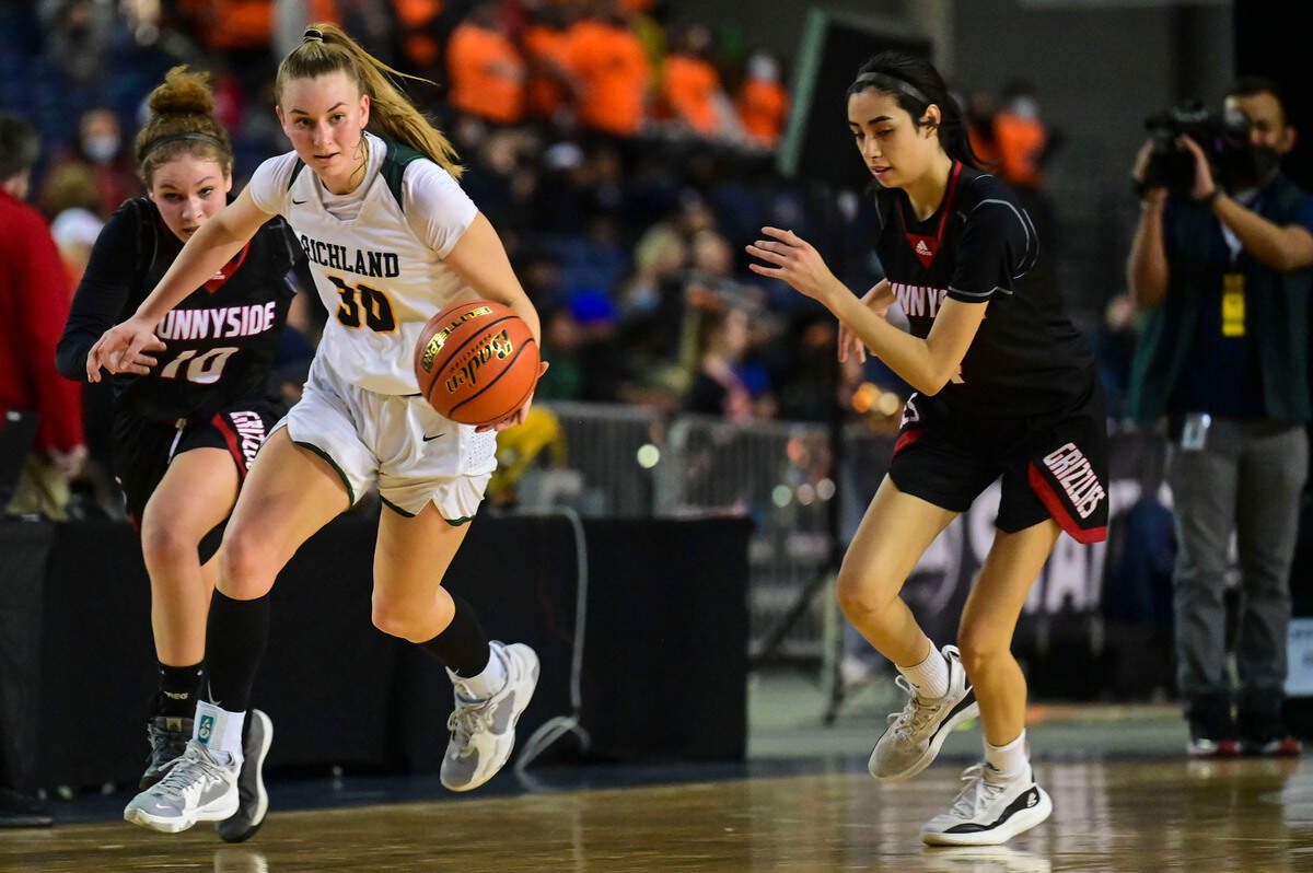 After grabbing a steal, Richland guard Kylee Fox (30) races up court as she is chased down by Sunnyside guard Paris Wilson (10) during the fourth quarter of a Class 3A state tournament game on Wednesday, March 2, 2022, at the Tacoma Dome, in Tacoma, Wash.