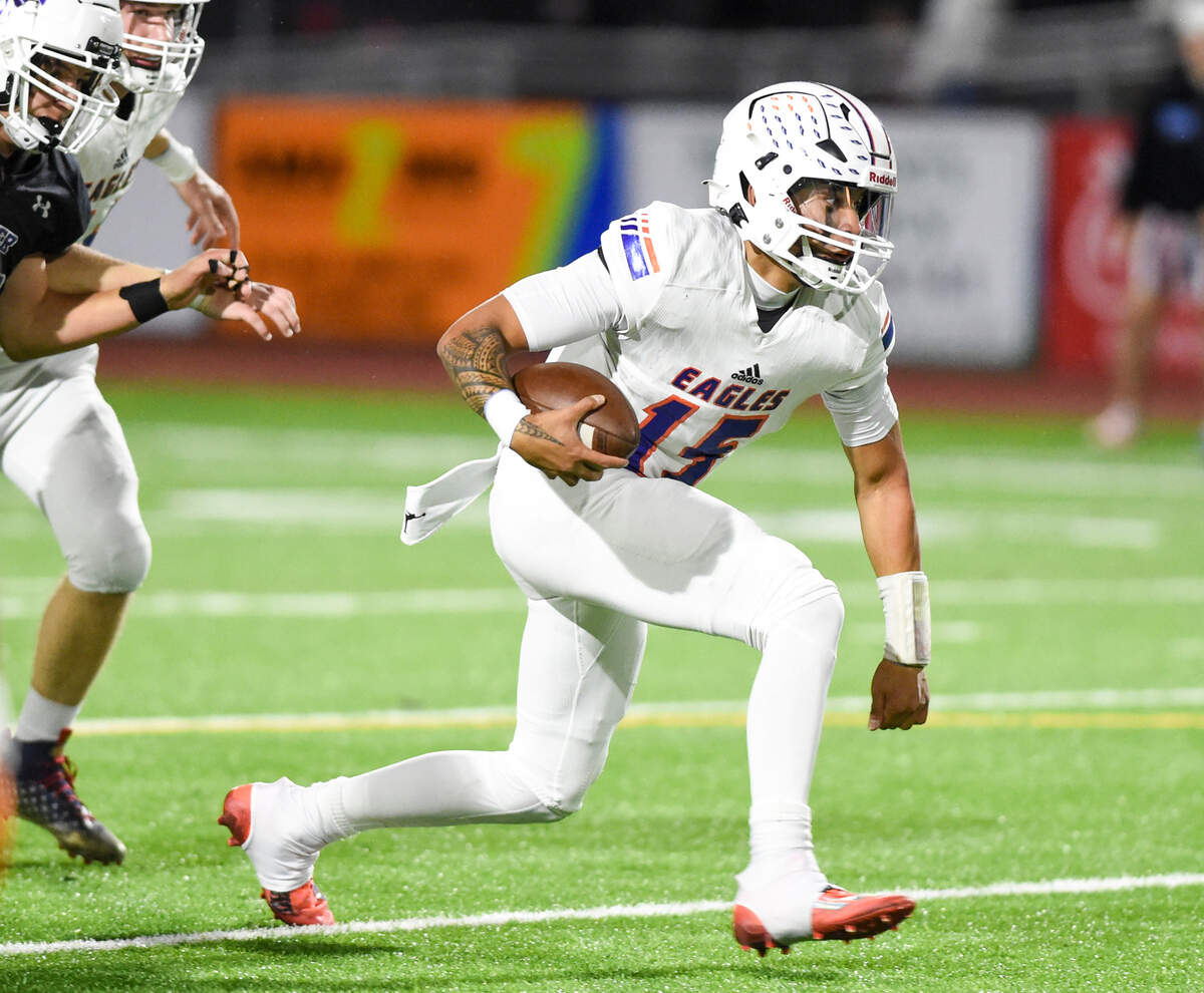 Graham-Kapowsin’s Daveon Superales (15) scrambles under pressure against the Sumner Spartans during the first half of the game at Sumner High School, Thursday, Sept. 28, 2023, in Sumner, Wash.
