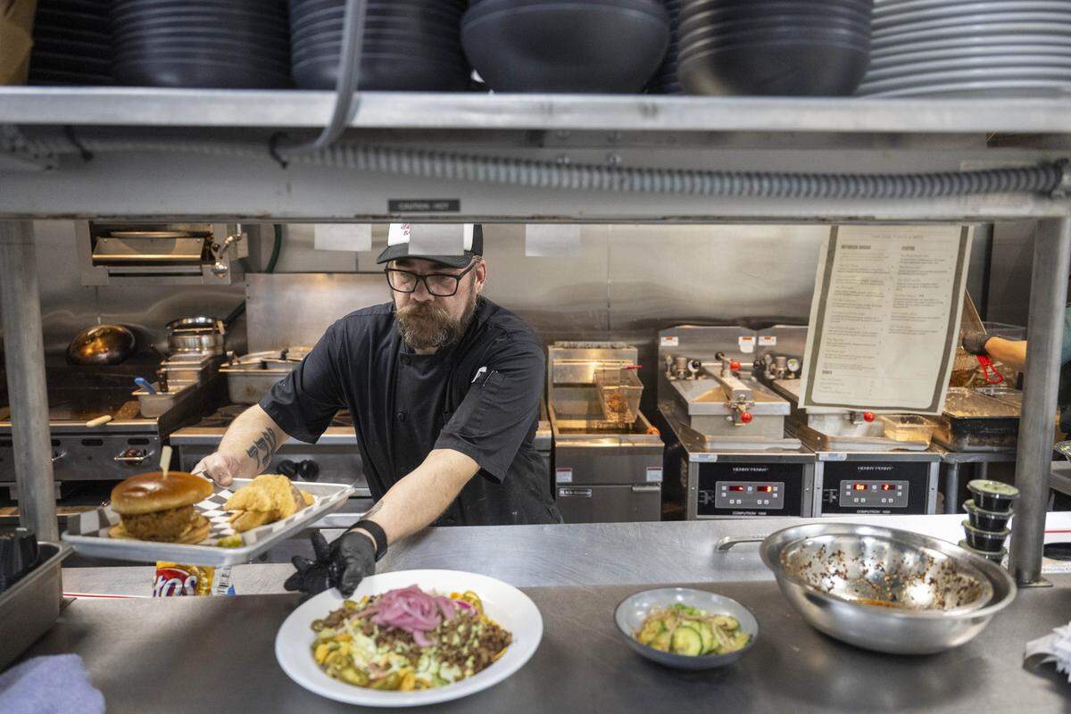 Kitchen Manager Chris Foutz prepares dishes in the kitchen of Terry's Bar and Grill on Wednesday, Jan. 7, 2026, in Tacoma, Wash.
