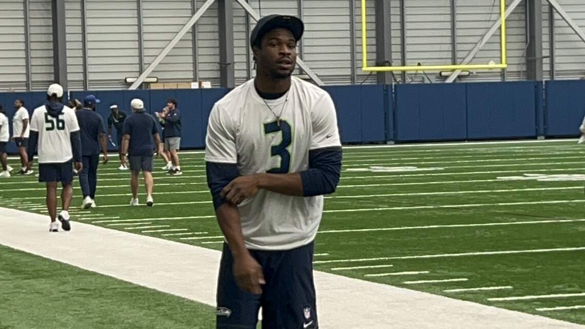 Nick Emmanwori strolls in cheerily to watch Seahawks walkthru 11th camp practice