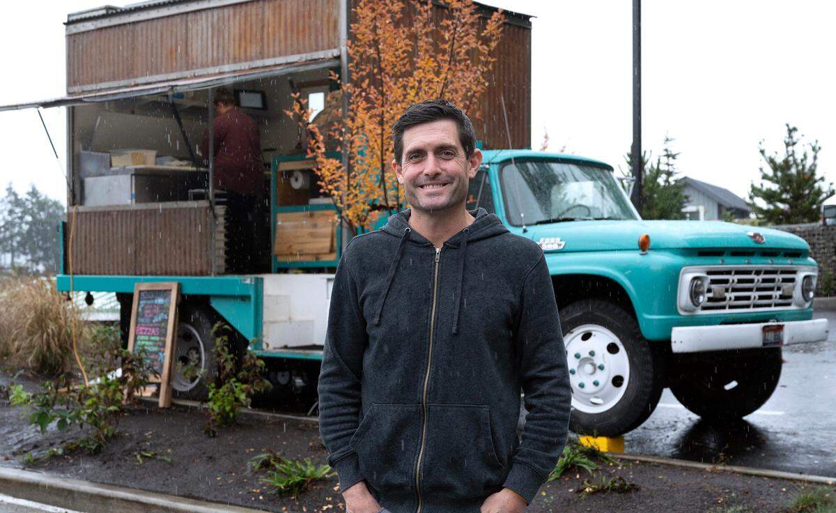Owner John Ross at his Millville at 7 Seas wood-fired pizza truck in the parking lot of 7 Seas Brewing on the waterfront in Gig Harbor, Washington, on Monday, Nov. 6, 2023.