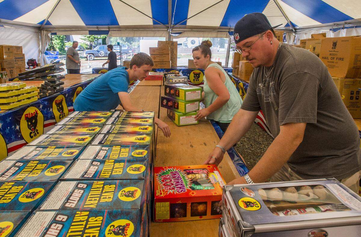 A crew sets up Lucky Dog Fireworks at 75th Street West and Bridgeport Way in Lakewood on June 27, 2016.