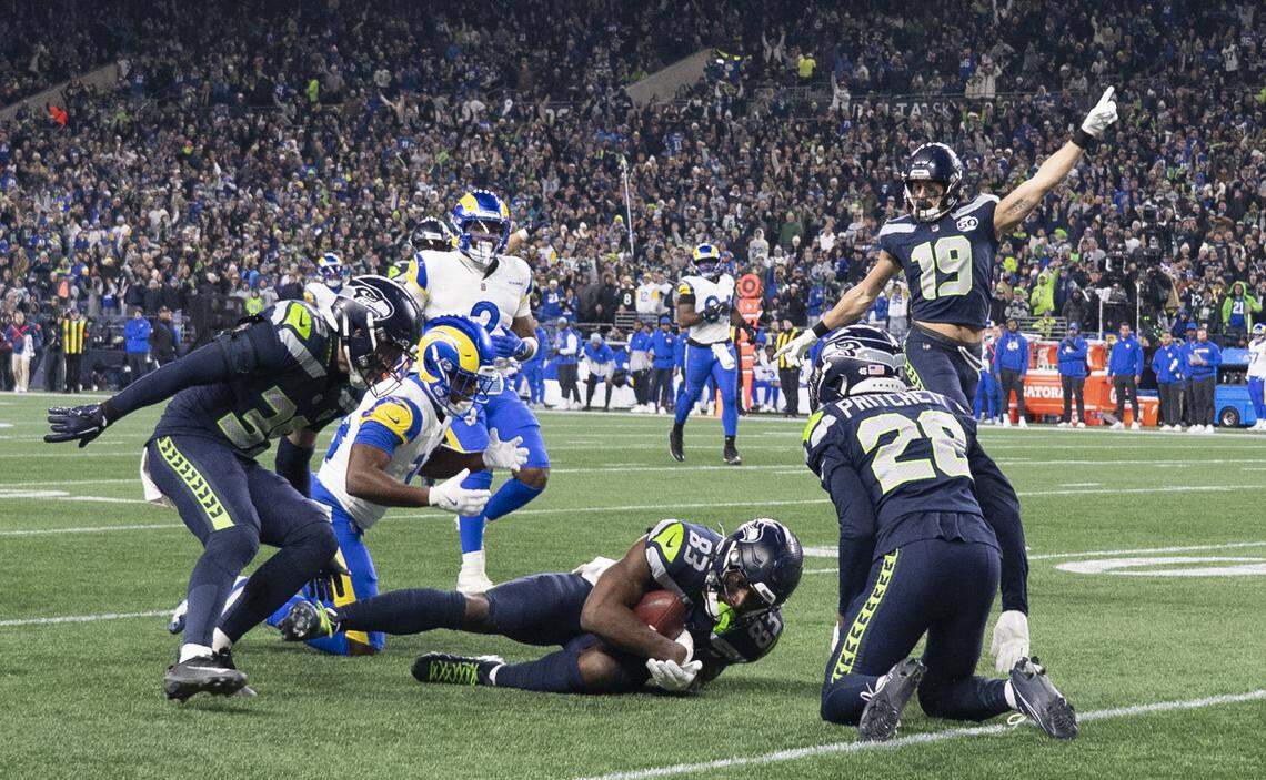 Seattle Seahawks wide receiver Dareke Young (83) recovers a muffed punt from Los Angeles Rams wide receiver Xavier Smith (19) during the third quarter of the NFC Championship game at Lumen Field, on Sunday, Jan. 25, 2026, in Seattle.