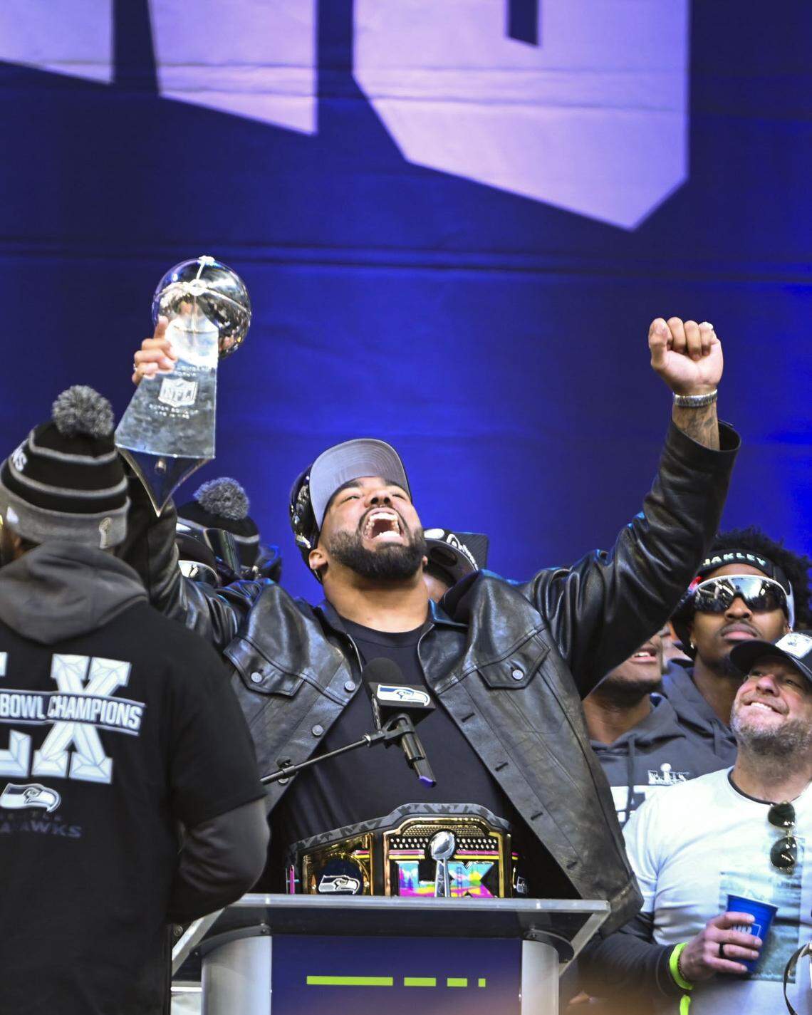 Seattle Seahawks defensive lineman Leonard Williams hoists the the Lombardi Trophy during the team’s Trophy Celebration event at Lumen Field on Wednesday, Feb. 11, 2026, in Seattle.