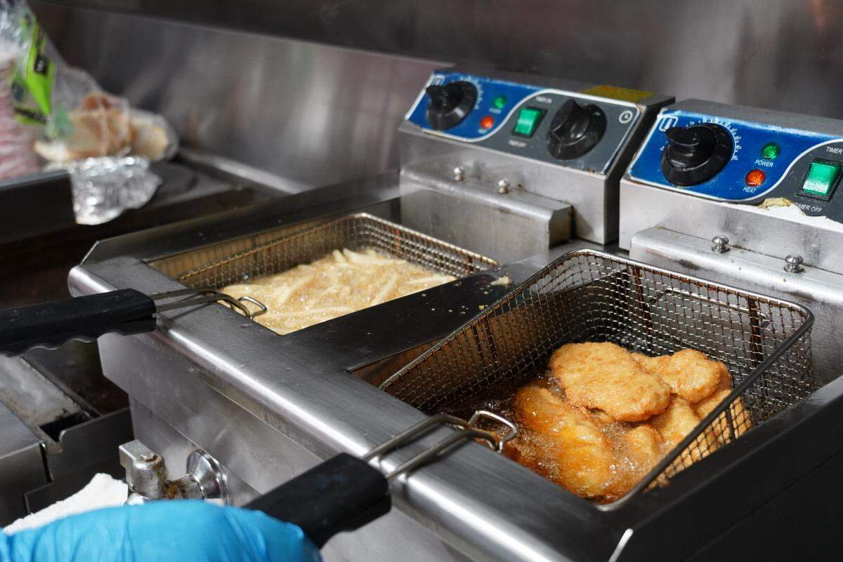French fries and chicken strips sizzle in oil for hungry families during Skate Night in Vaughn, Wash., Friday, Feb. 13, 2026.