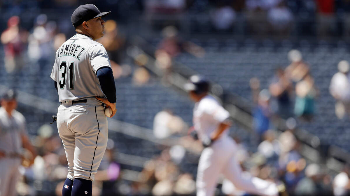 Seattle Mariners starting pitcher Erasmo Ramirez, left, looks on as the San Diego Padres’ Hunter Renfroe, right, rounds the bases after hitting a three-run home run during the third inning of a baseball game Wednesday, Aug. 29, 2018, in San Diego. (AP Photo/Gregory Bull)