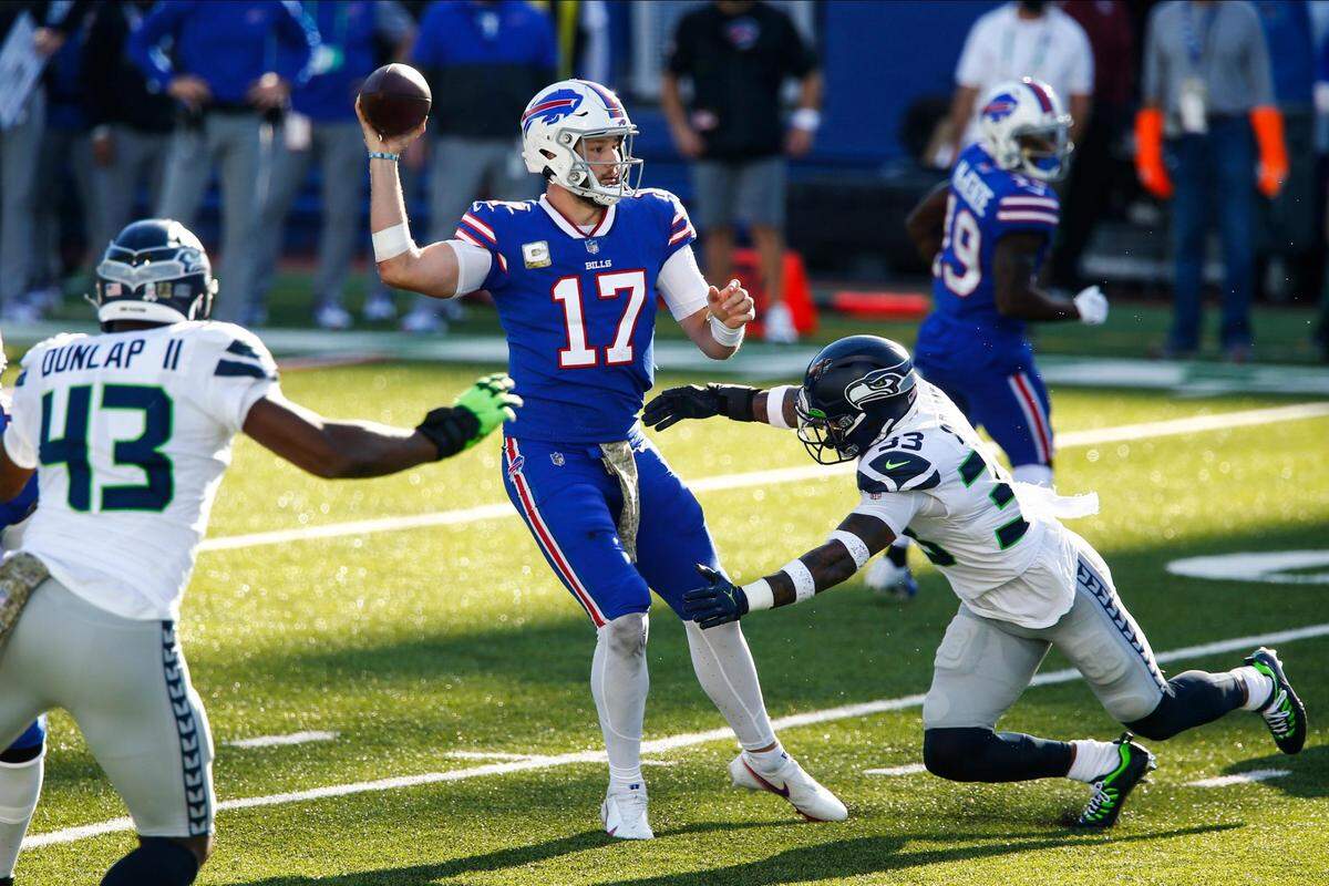 Buffalo Bills’ Josh Allen (17) throws a pass over Seattle Seahawks’ Jamal Adams (33) for a touchdown during the first half of an NFL football game Sunday, Nov. 8, 2020, in Orchard Park, N.Y. (AP Photo/John Munson)