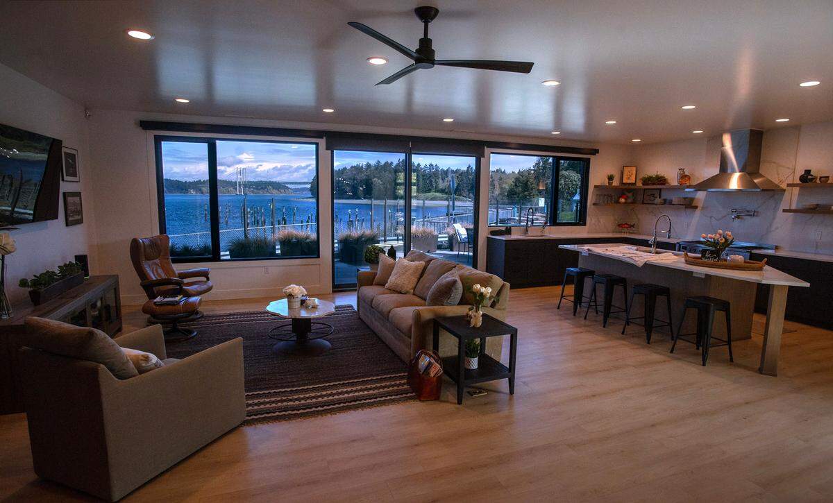The Tacoma Narrows Bridge and the Puget Sound are framed through the living room windows of the residential home in the renovated Steamer’s restaurant building on the waterfront at Titlow Beach in Tacoma, Washington, on Tuesday, April 9, 2024. The property is listed with broker Anne Watkins of Morrison House Sotheby’s International Realty at $2,579,000.