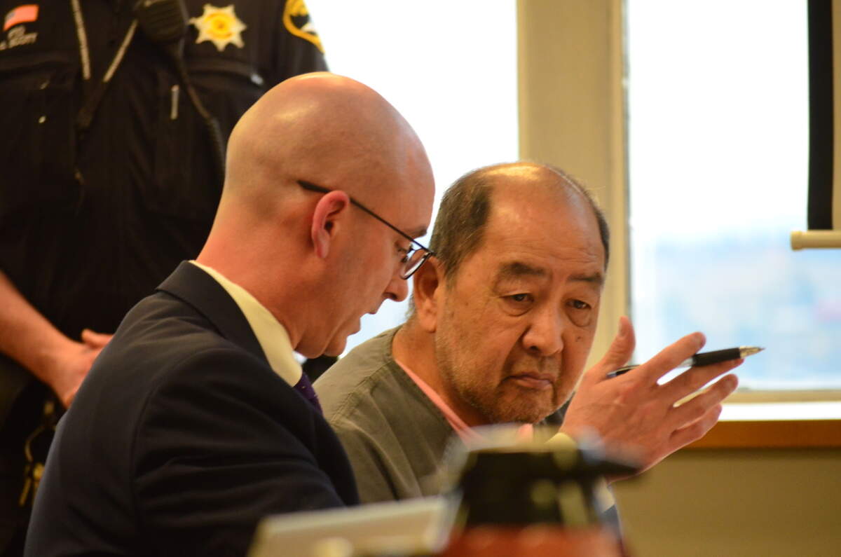 Yoon Bang, right, listens to his defense attorney, Jared Ausserer, during his sentencing hearing Friday, Jan. 27, 2023, in Pierce County Superior Court. Bang, 74, was convicted in a jury trial of second-degree murder for fatally shooting a contractor who was working on a remodel of the defendant’s bathroom.