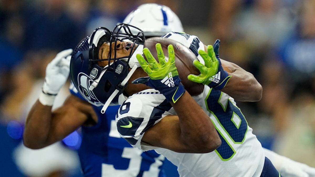 Seattle Seahawks wide receiver Tyler Lockett (16) makes catch for a touchdown in front of Indianapolis Colts safety Khari Willis (37) in the first half of an NFL football game in Indianapolis, Sunday, Sept. 12, 2021. (AP Photo/Charlie Neibergall)