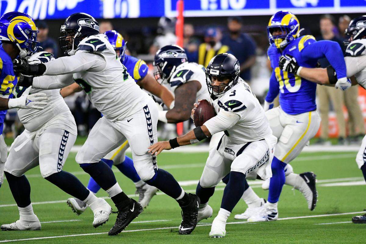 Seattle Seahawks quarterback Russell Wilson runs out of the pocket during the second half of an NFL football game against the Los Angeles Rams Tuesday, Dec. 21, 2021, in Inglewood, Calif. (AP Photo/Kevork Djansezian)