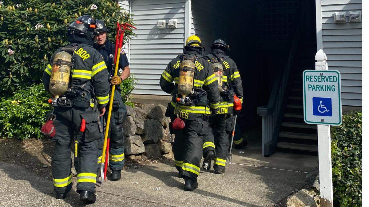 Gig Harbor firefighters at a fire scene earlier this year. Air packs like these will cost $1.7 million to replace.