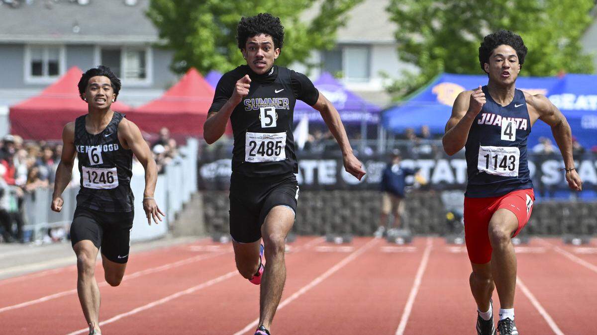 Sumner’s Izear Ferguson, center, pushes ahead in the 4A Boys 100M Dash final on Saturday, May 30, 2026, at the 2026 State Track & Field Championships in Tacoma, Wash. Ferguson finished in first.