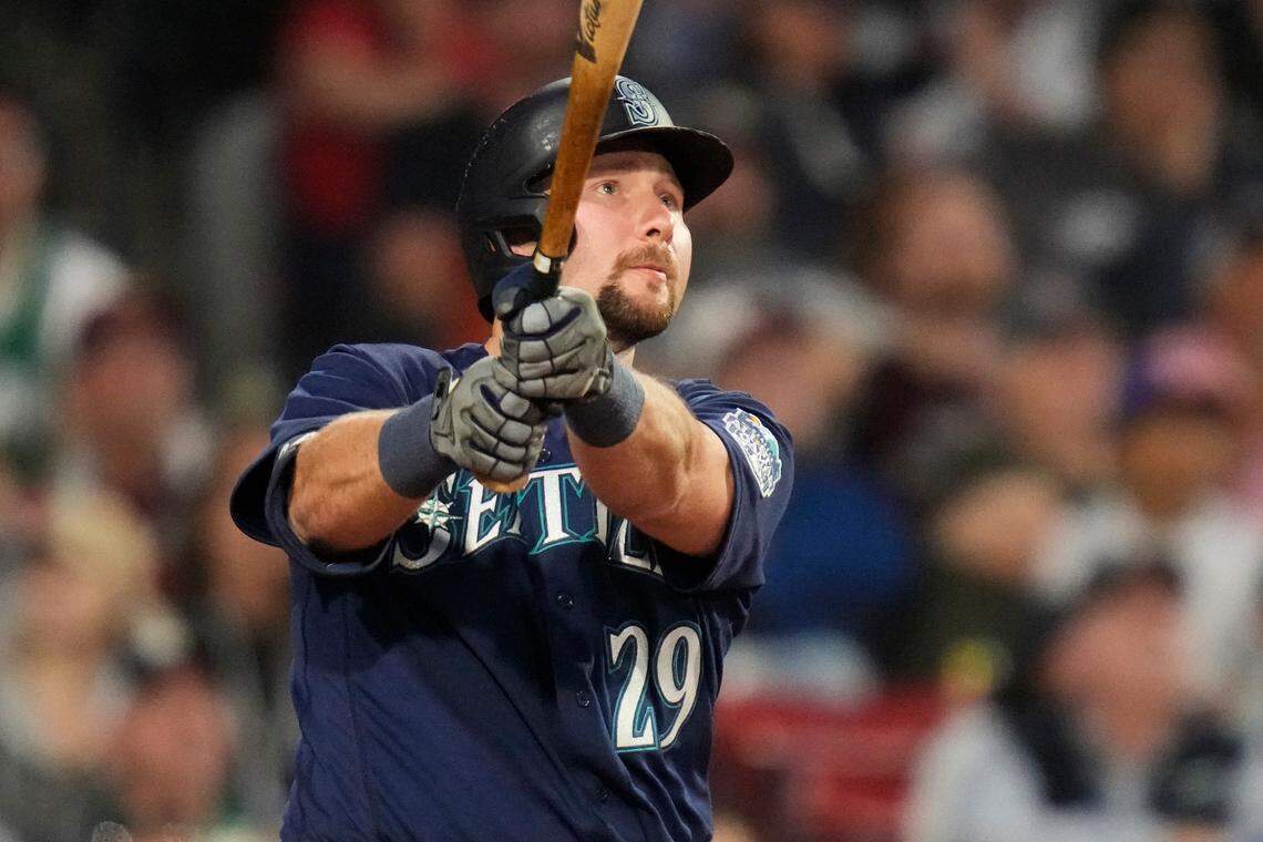 Seattle Mariners’ Cal Raleigh watches the flight of his two-run home run off Boston Red Sox starting pitcher Tanner Houck during the fifth inning of a baseball game at Fenway Park, Monday, May 15, 2023, in Boston. (AP Photo/Charles Krupa)