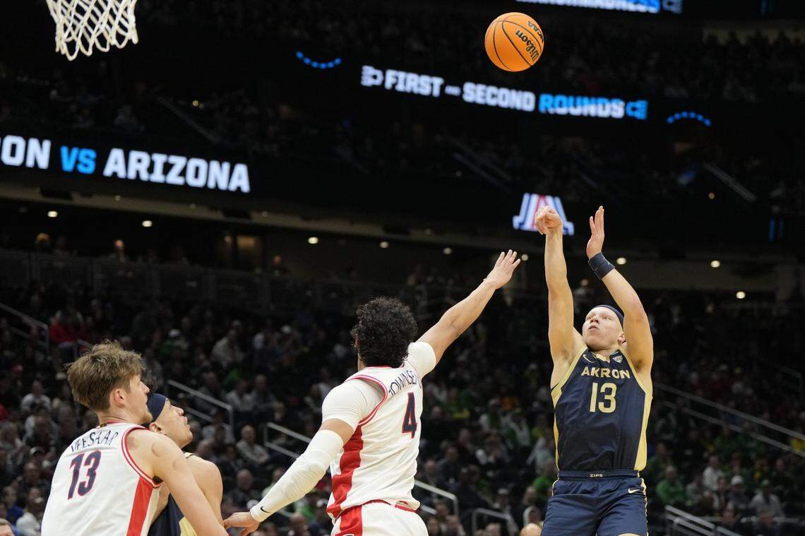 Mar 21, 2025; Seattle, WA, USA; Akron Zips guard Isaiah Gray (13) shoots the ball over Arizona Wildcats forward Trey Townsend (4) during the first half in the first round of the NCAA Tournament at Climate Pledge Arena. Mandatory Credit: Stephen Brashear-Imagn Images