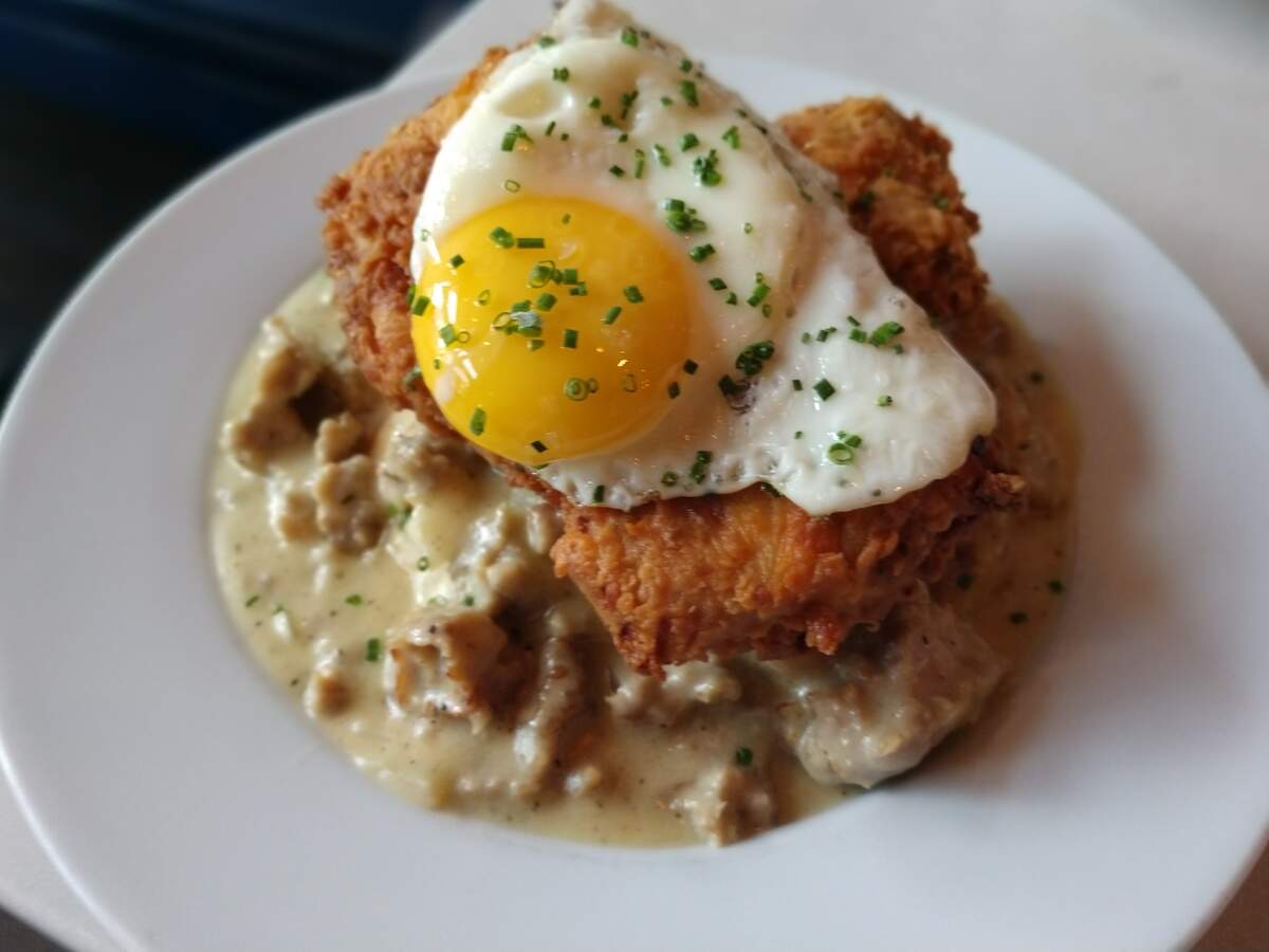 Biscuits and gravy with a sunnyside up egg and fried chicken from downtown Tacoma’s Wooden City.