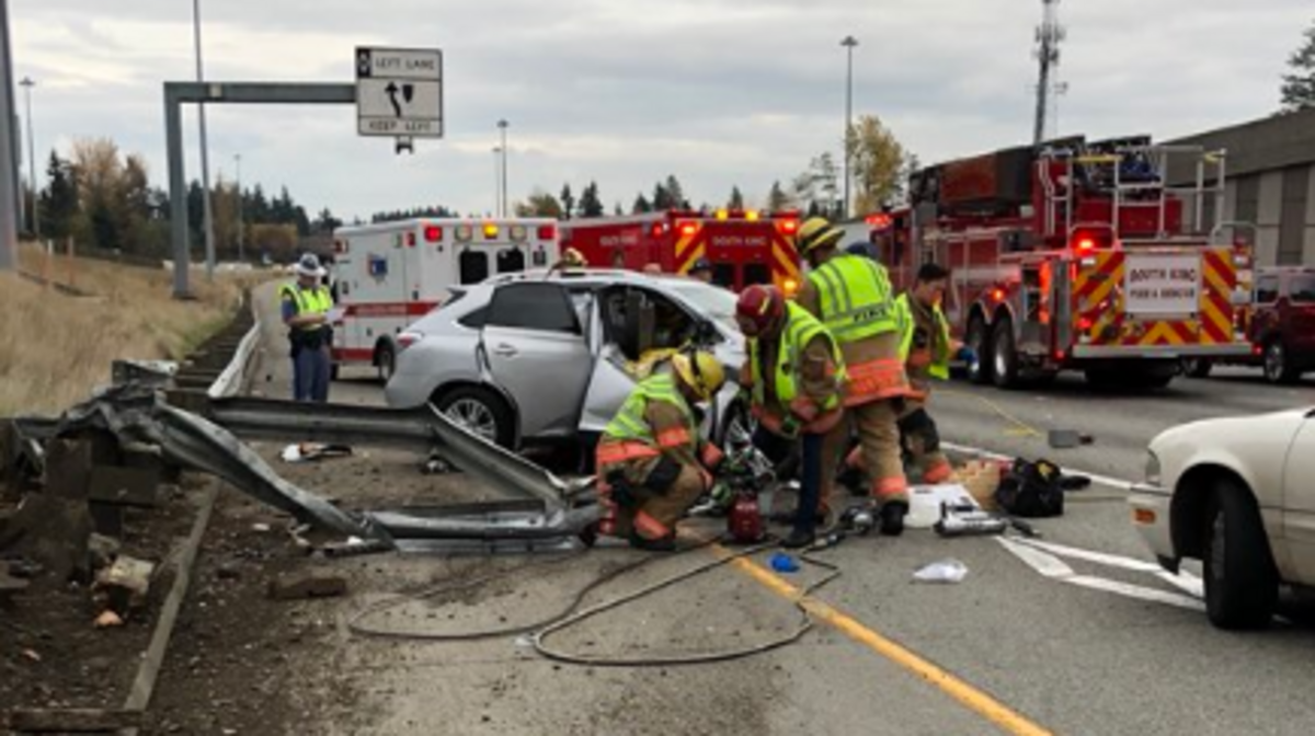 First responders work at the scene of a fatal car wreck on Interstate 5 Saturday afternoon. A woman died as the result of the collision, according to the Washington State Patrol.