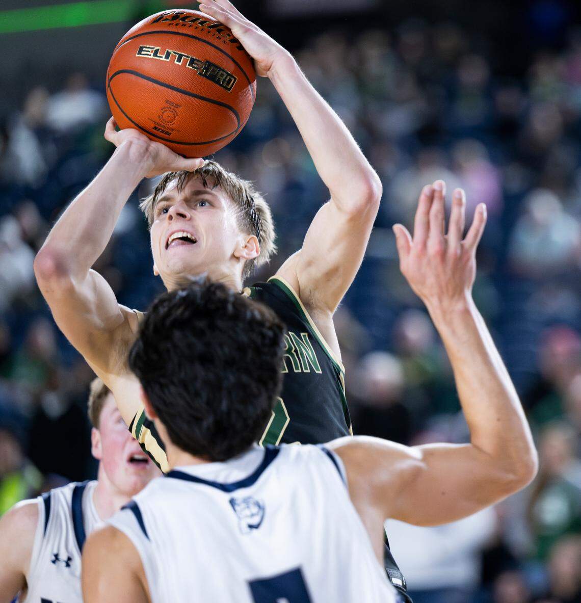 Auburn’s Carter Hansen (2) goes up agsint Gonzaga Prep’s Brogan Howell (5) during the overtime of a Class 4A state basketball tournament quarterfinal game at the Tacoma Dome on Thursday, March 6, 2025, in Tacoma, Wash.