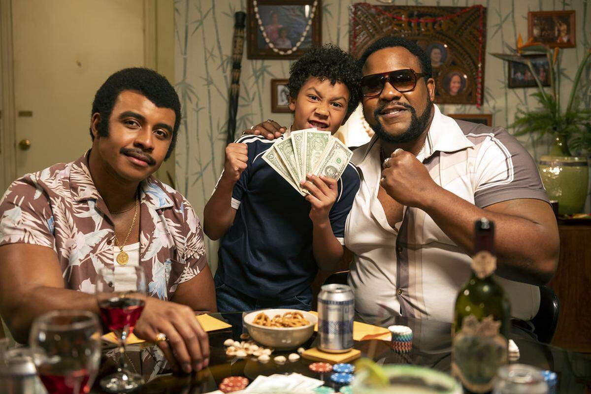 Tacoma comedian and actor Nate Jackson (right) is a cast member of the new NBC sitcom “Young Rock” based on the life of superstar Dwayne Johnson. Jackson plays pro wrestler Junkyard Dog. Joseph Lee Anderson (left) plays Rocky Johnson and Adrian Groulx stars as the young Rock.