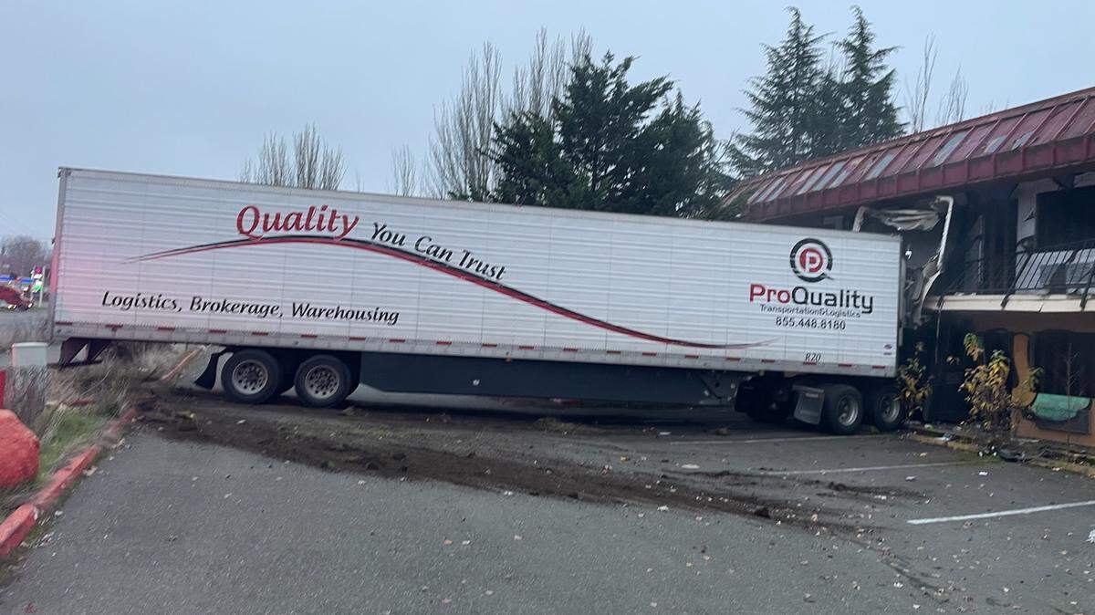 The roadway is closed on Pacific Highway in Fife after a semi-truck crashed into a hotel on Dec. 3.