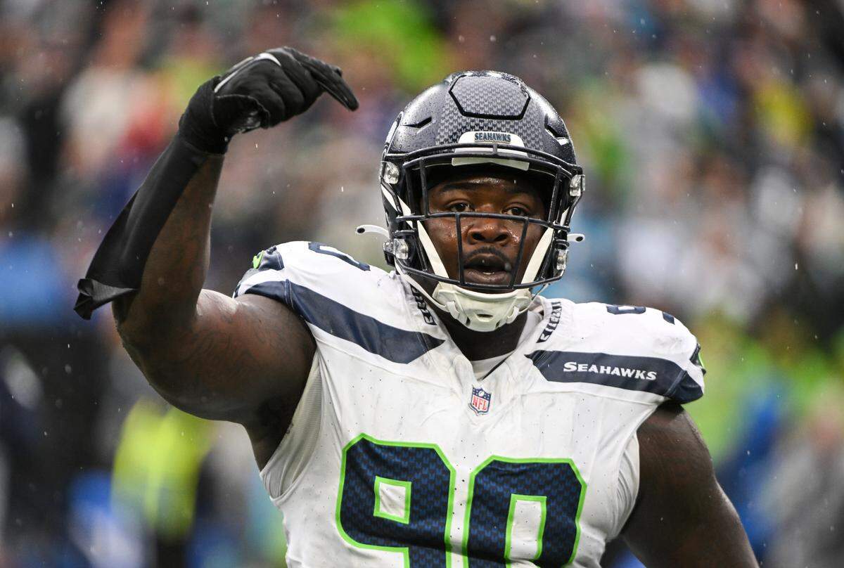 Seattle Seahawks defensive tackle Jarran Reed (90) reacts to a sack on Carolina Panthers quarterback Andy Dalton (14) during the fourth quarter of the game at Lumen Field, Sunday, Sept. 24, 2023, Seattle, Wash.