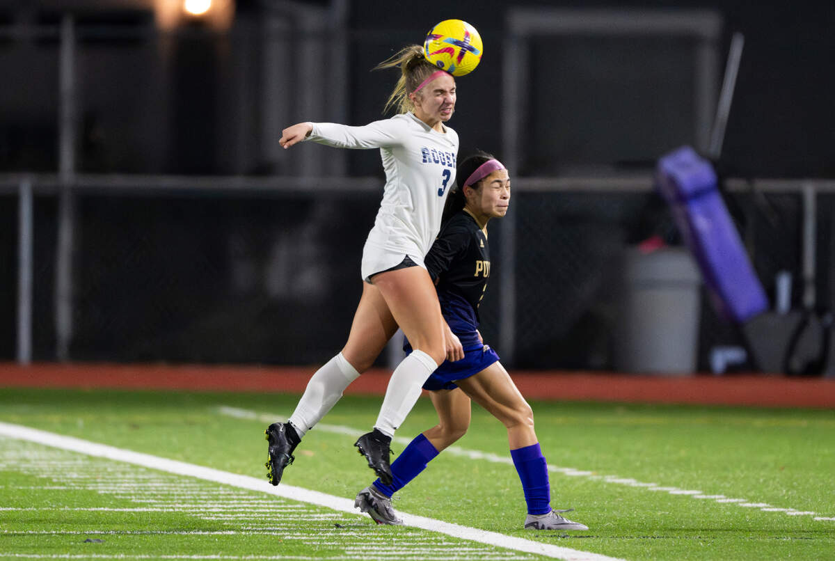 Rogers’ Lindy Strowbridge (3) heads the ball over Puyallup’s Aaliyah Reyna (3) during the match at Sparks Stadium, on Tuesday, Oct. 29, 2024 in Puyallup, Wash.