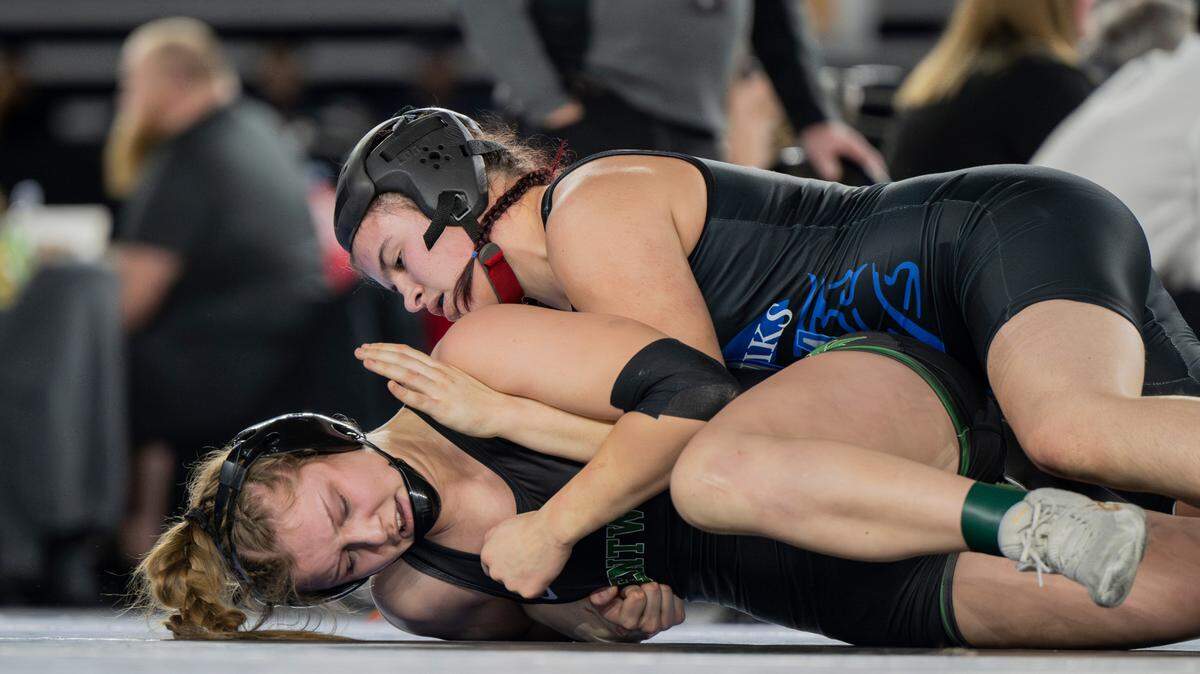 Curtis’ Clarissa Wangen works to pin Kentwood’s Sarah Wright in the 155-pound 3A championship match during day two of the Mat Classic XXXV at the Tacoma Dome on Saturday, Feb. 17, 2024, in Tacoma, Washington.