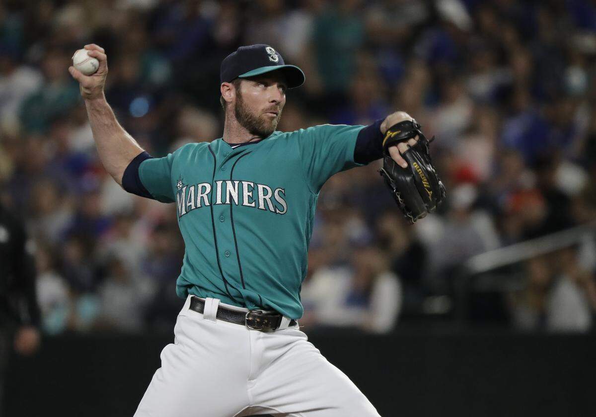 Seattle Mariners infielder Andrew Romine pitches against the Los Angeles Dodgers during the ninth inning of a baseball game Friday, Aug. 17, 2018, in Seattle. (AP Photo/Ted S. Warren)