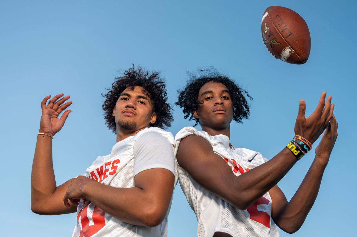 Lakes running back Leo Pulalasi (left) and receiver David Wells pose for a portrait at Lakes High School on Wednesday, Aug. 17, 2022, in Lakewood.